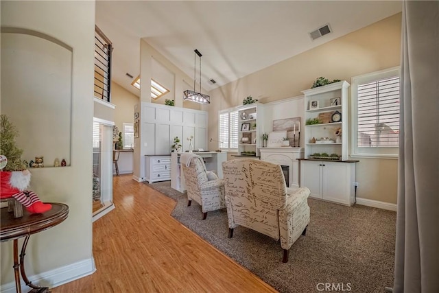 1122 Moonbeam Way, Turlock, CA 95382 - living area featuring high vaulted ceiling, light wood finished floors, and baseboards