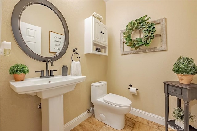 1122 Moonbeam Way, Turlock, CA 95382 - half bath featuring baseboards, toilet, and a sink