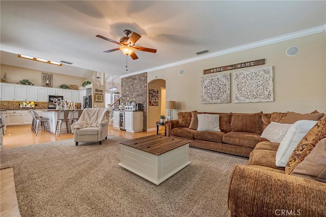 1122 Moonbeam Way, Turlock, CA 95382 - living area featuring arched walkways, a ceiling fan, and crown molding
