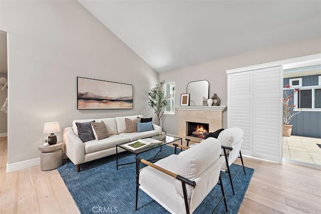 1890 Orange Ave, Costa Mesa, CA 92627 - living area featuring hardwood / wood-style flooring, a tiled fireplace, and high vaulted ceiling