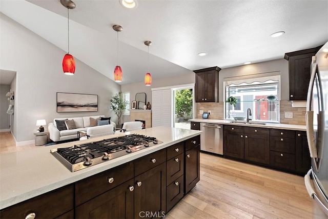 1890 Orange Ave, Costa Mesa, CA 92627 - kitchen featuring stainless steel appliances, decorative backsplash, light countertops, dark brown cabinets, and lofted ceiling