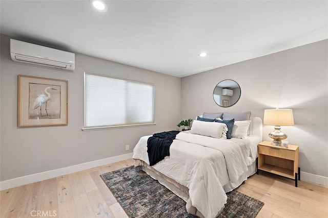 1890 Orange Ave, Costa Mesa, CA 92627 - bedroom with a wall mounted air conditioner, light wood-type flooring, and recessed lighting