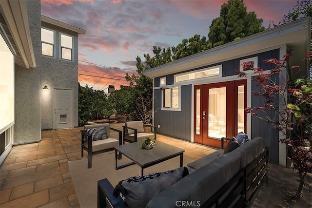 1890 Orange Ave, Costa Mesa, CA 92627 - patio terrace at dusk featuring a patio, an outdoor living space, and an outbuilding