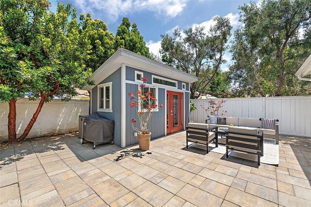 1890 Orange Ave, Costa Mesa, CA 92627 - fenced backyard featuring a patio area, an outdoor living space, and an outdoor structure