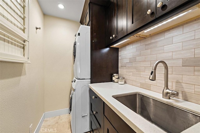1890 Orange Ave, Costa Mesa, CA 92627 - kitchen featuring estacked washer and dryer, backsplash, and dark brown cabinetry