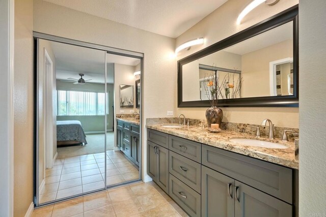 3332 Heather Ridge Ct, San Marcos, CA 92078 - ensuite bathroom featuring double vanity, ceiling fan, tile patterned flooring, and baseboards