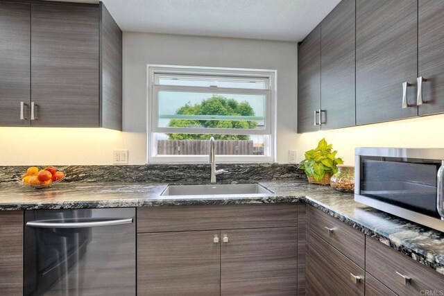 3332 Heather Ridge Ct, San Marcos, CA 92078 - kitchen featuring appliances with stainless steel finishes, a sink, modern cabinets, and dark stone countertops