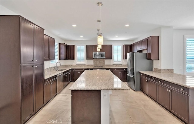 13029 Waterlily Way, Chino, CA 91710 - kitchen featuring appliances with stainless steel finishes, healthy amount of natural light, a kitchen island, dark brown cabinetry, and recessed lighting