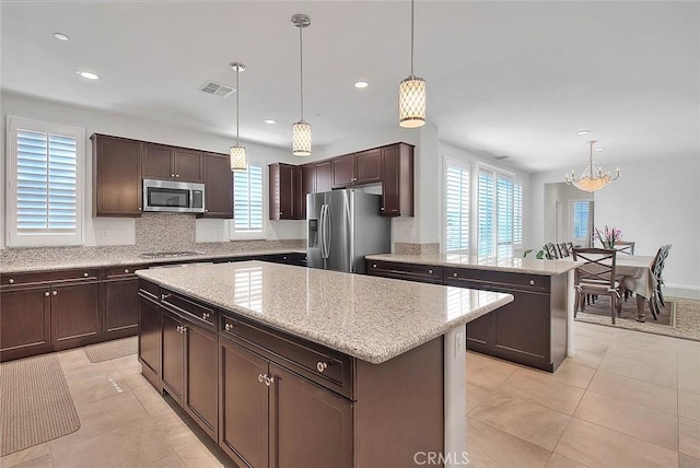 13029 Waterlily Way, Chino, CA 91710 - kitchen with appliances with stainless steel finishes, plenty of natural light, a center island, a chandelier, and recessed lighting
