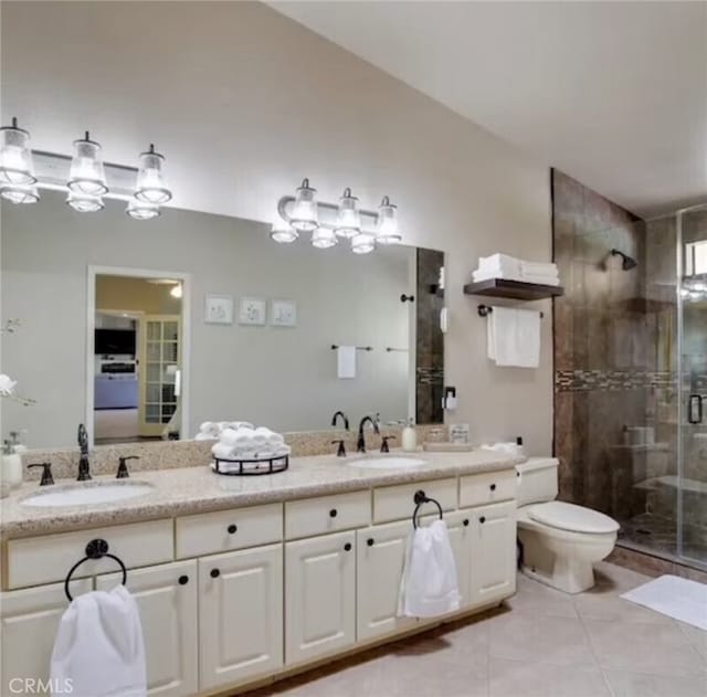 43300 Warner Trl, Palm Desert, CA 92211 - bathroom with double vanity, a stall shower, tile patterned flooring, and toilet