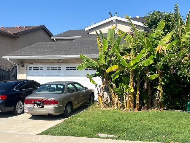 17506 Sandlake Ave, Carson, CA 90746 - view of home's exterior with a garage, concrete driveway, a lawn, and a shingled roof