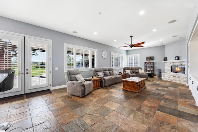 12428 Palmer Dr, Moorpark, CA 93021 - living room featuring stone tile flooring, ceiling fan, recessed lighting, a stone fireplace, and french doors