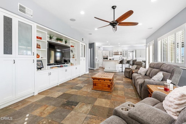 12428 Palmer Dr, Moorpark, CA 93021 - living area featuring stone tile flooring, ceiling fan, and recessed lighting