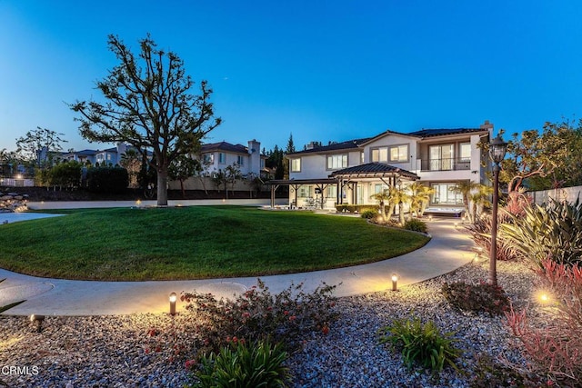 12428 Palmer Dr, Moorpark, CA 93021 - view of front facade featuring solar panels, a chimney, a front lawn, and stucco siding