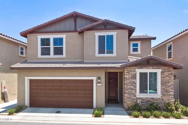 275 Fuerte Dr, Santa Paula, CA 93060 - view of front facade featuring stone siding, a garage, and stucco siding