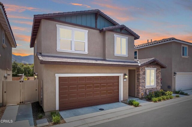 275 Fuerte Dr, Santa Paula, CA 93060 - view of front of property with an attached garage, stucco siding, a tiled roof, stone siding, and board and batten siding
