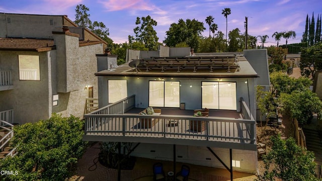 22769 Macfarlane Dr, Woodland Hills, CA 91364 - back of house at dusk with stucco siding and a deck