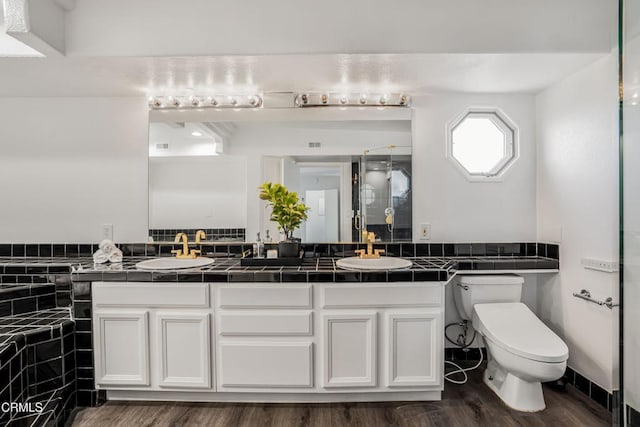 22769 Macfarlane Dr, Woodland Hills, CA 91364 - full bathroom with double vanity, wood finished floors, and a stall shower