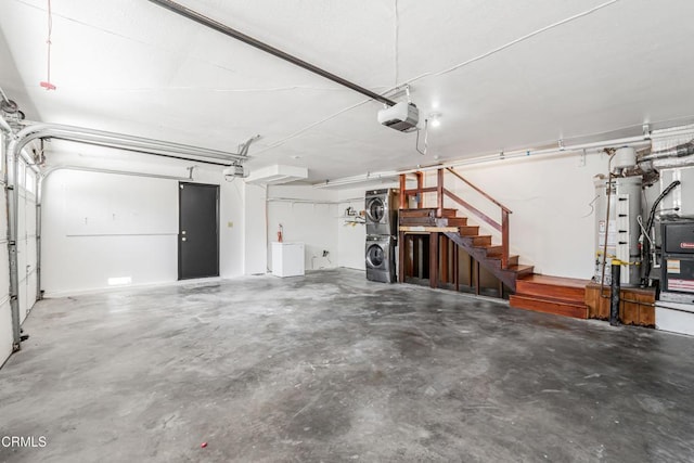 22769 Macfarlane Dr, Woodland Hills, CA 91364 - garage with stacked washing machine and dryer, gas water heater, and a garage door opener