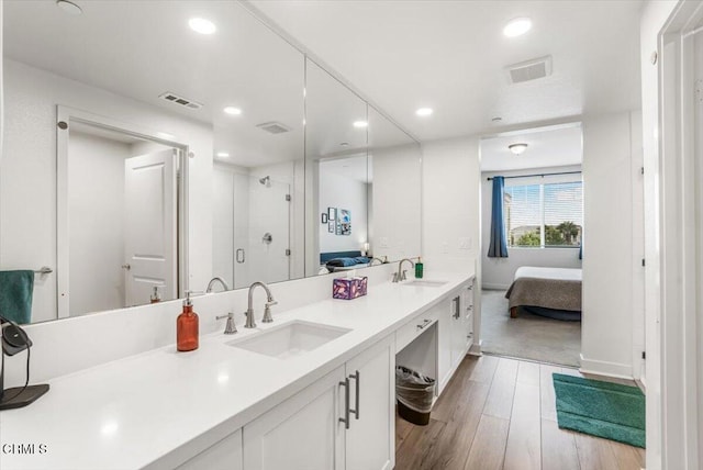 2830 Wagon Wheel Rd Unit 304, Oxnard, CA 93036 - full bath with ensuite bathroom, double vanity, a shower stall, wood finished floors, and recessed lighting