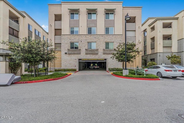 2830 Wagon Wheel Rd Unit 304, Oxnard, CA 93036 - view of building exterior with a garage and asphalt driveway