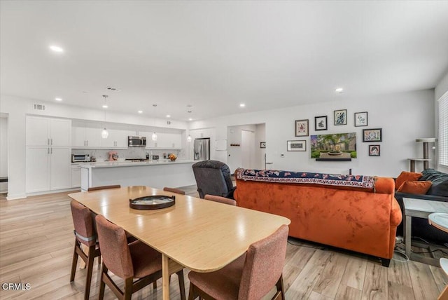 2830 Wagon Wheel Rd Unit 304, Oxnard, CA 93036 - dining area featuring light wood-style floors and recessed lighting