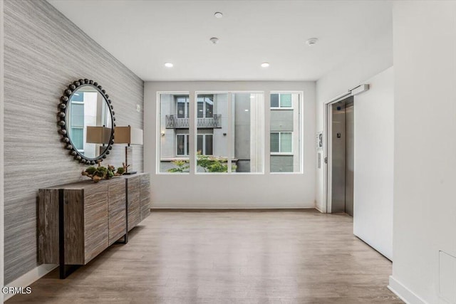 2830 Wagon Wheel Rd Unit 304, Oxnard, CA 93036 - hallway featuring wood finished floors, elevator, and recessed lighting