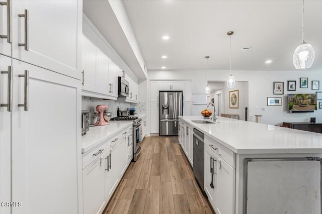 2830 Wagon Wheel Rd Unit 304, Oxnard, CA 93036 - kitchen featuring appliances with stainless steel finishes, light countertops, white cabinets, recessed lighting, and light wood-style floors