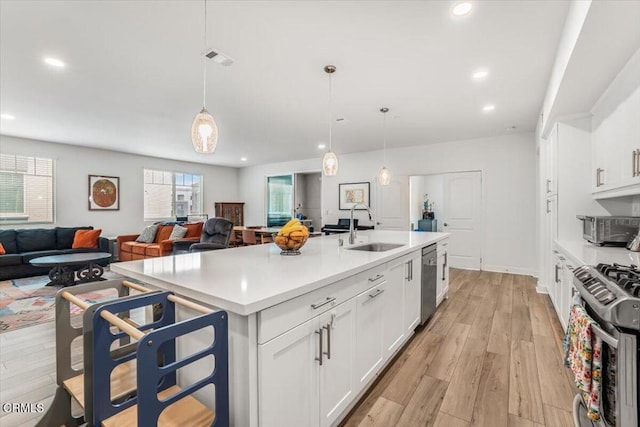 2830 Wagon Wheel Rd Unit 304, Oxnard, CA 93036 - kitchen featuring stainless steel appliances, recessed lighting, light countertops, light wood-style floors, and white cabinetry