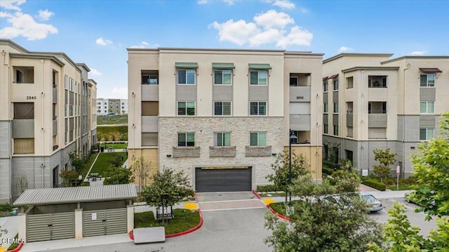 2830 Wagon Wheel Rd Unit 304, Oxnard, CA 93036 - view of property featuring driveway and an attached garage