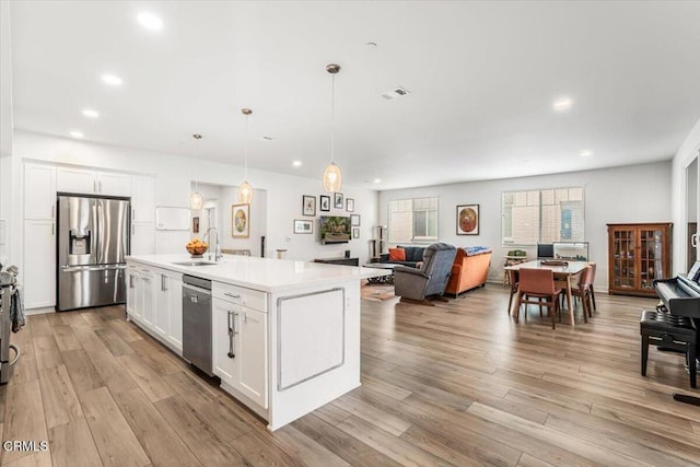 2830 Wagon Wheel Rd Unit 304, Oxnard, CA 93036 - kitchen with appliances with stainless steel finishes, open floor plan, white cabinetry, light countertops, and recessed lighting