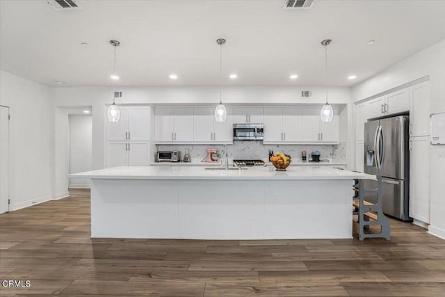 2830 Wagon Wheel Rd Unit 304, Oxnard, CA 93036 - kitchen with appliances with stainless steel finishes, light countertops, white cabinetry, dark wood-style flooring, and recessed lighting