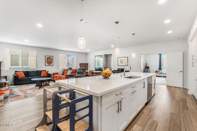 2830 Wagon Wheel Rd Unit 304, Oxnard, CA 93036 - kitchen featuring recessed lighting, white cabinets, light countertops, light wood-style floors, and open floor plan