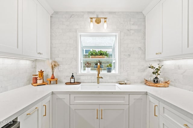 5222 Whitecap St, Oxnard, CA 93035 - kitchen with backsplash, white cabinetry, and light countertops