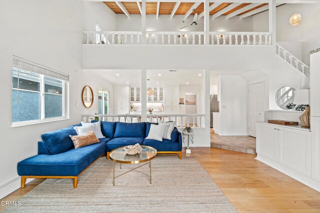 5222 Whitecap St, Oxnard, CA 93035 - living room featuring light wood-style flooring, a towering ceiling, and a wood ceiling with exposed beams