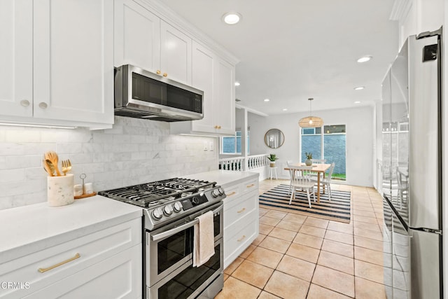 5222 Whitecap St, Oxnard, CA 93035 - kitchen featuring stainless steel appliances, light countertops, white cabinets, tasteful backsplash, and recessed lighting