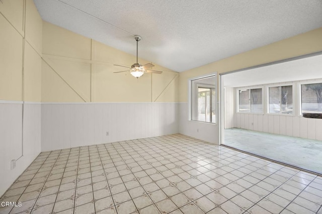 5576 Holly Ridge Dr, Camarillo, CA 93012 - unfurnished room with ceiling fan, lofted ceiling, a textured ceiling, and wainscoting