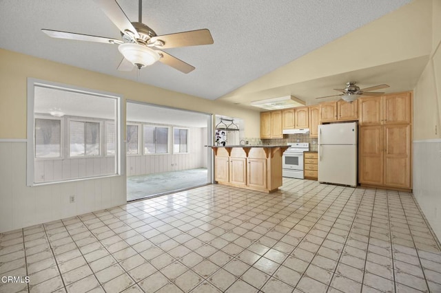 5576 Holly Ridge Dr, Camarillo, CA 93012 - kitchen featuring white appliances, a ceiling fan, light brown cabinetry, vaulted ceiling, and a textured ceiling