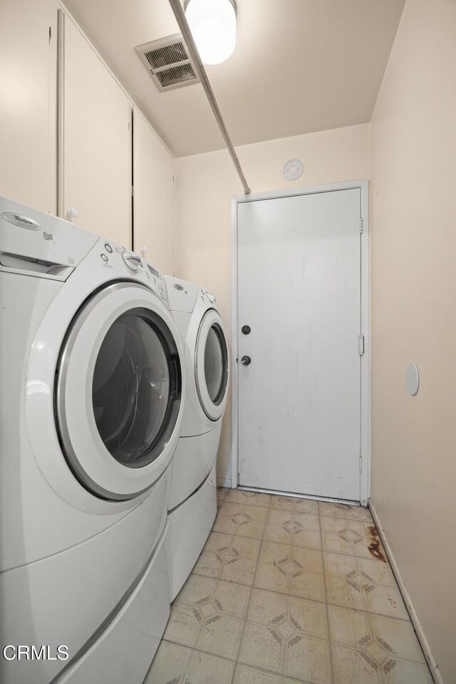 5576 Holly Ridge Dr, Camarillo, CA 93012 - washroom featuring separate washer and dryer, light floors, and cabinet space