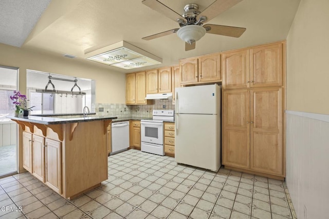 5576 Holly Ridge Dr, Camarillo, CA 93012 - kitchen with white appliances, under cabinet range hood, a peninsula, light brown cabinets, and wainscoting