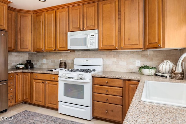 2250 Cooley Pl, Pasadena, CA 91104 - kitchen featuring white appliances, brown cabinetry, and backsplash