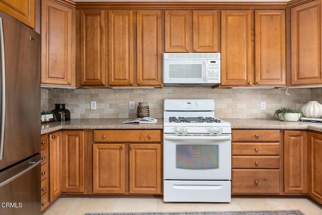 2250 Cooley Pl, Pasadena, CA 91104 - kitchen featuring white appliances, brown cabinets, decorative backsplash, and light stone counters