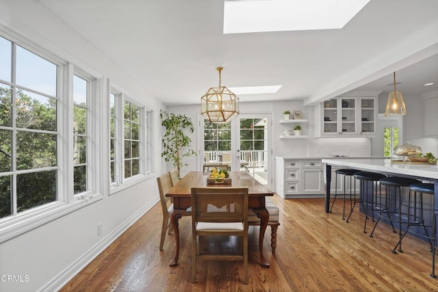 1550 Scenic Dr, Pasadena, CA 91103 - dining area featuring a skylight, wood finished floors, and a chandelier