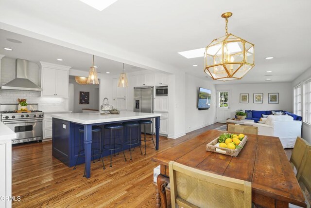1550 Scenic Dr, Pasadena, CA 91103 - dining area with a skylight, wood finished floors, a chandelier, and recessed lighting