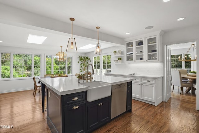1550 Scenic Dr, Pasadena, CA 91103 - kitchen featuring stainless steel dishwasher, a skylight, light countertops, white cabinetry, and recessed lighting