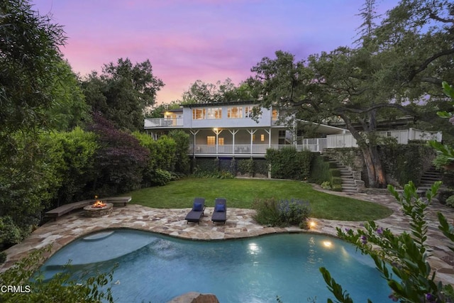 1550 Scenic Dr, Pasadena, CA 91103 - rear view of property with stairway, a fire pit, a lawn, a patio area, and an outdoor pool