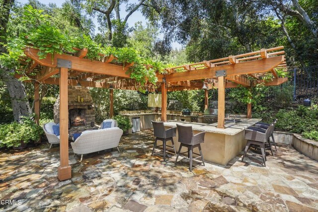 1550 Scenic Dr, Pasadena, CA 91103 - view of patio / terrace with an outdoor stone fireplace, an outdoor bar, exterior kitchen, and a pergola