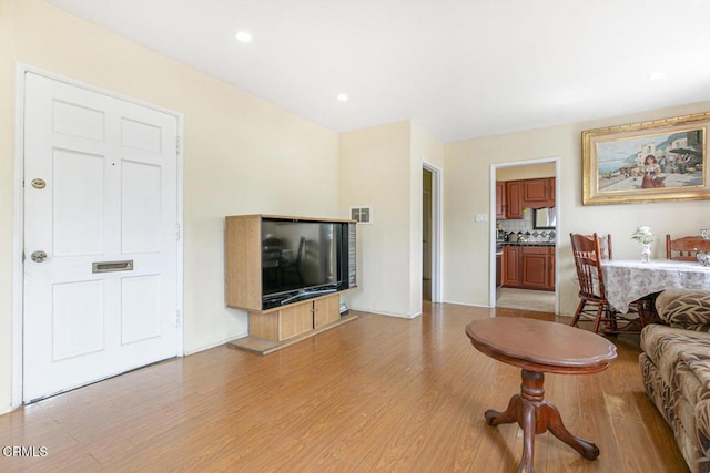 15207 Lorne St, Panorama City, CA 91402 - living room featuring light wood-type flooring and recessed lighting