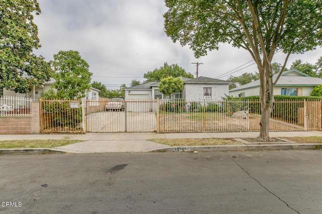 15207 Lorne St, Panorama City, CA 91402 - view of front facade featuring a fenced front yard, a gate, stucco siding, and a garage