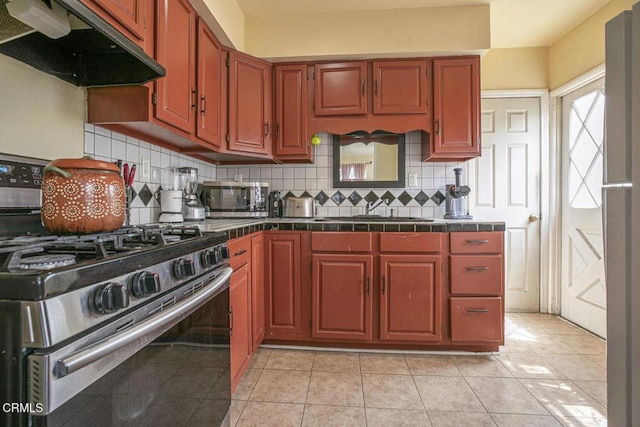 15207 Lorne St, Panorama City, CA 91402 - kitchen featuring appliances with stainless steel finishes, under cabinet range hood, decorative backsplash, tile countertops, and light tile patterned floors